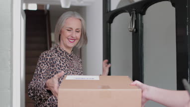 Mature woman signing for a home delivery
