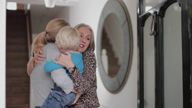 Grandmother opening door to visiting family