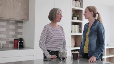 Mature adult woman with grown up daughter catching up over coffee