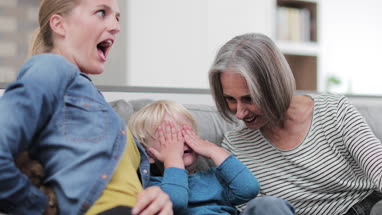 Child playing with mother and grandmother
