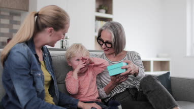 Grandchild giving grandmother a present