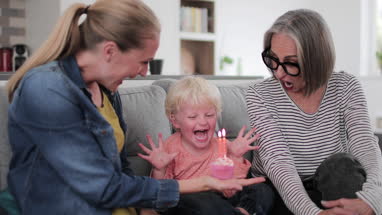 Boy blowing out birthday candles