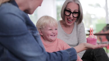 Boy blowing out birthday candles