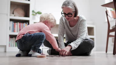 Grandmother helping grandchild count pocket money