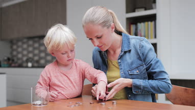Mother helping child count pocket money