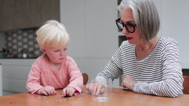 Grandmother helping grandchild count pocket money