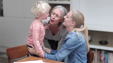 Grandchild giving Grandmother a kiss goodbye