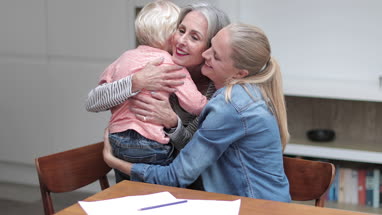 Grandchild giving Grandmother a hug goodbye