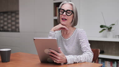 Mature adult female using a digital tablet