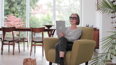 Mature adult female on a videocall to family