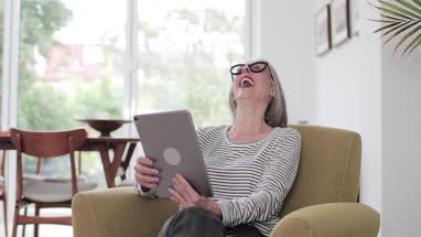 Mature adult female on a videocall to family