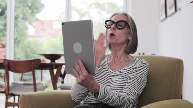 Mature adult female on a videocall to family