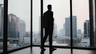 Businessman looking out at city skyline 