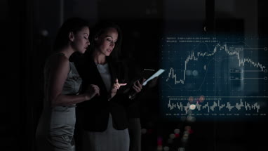 Conceptual shot of businesswomen with infographics digital composite