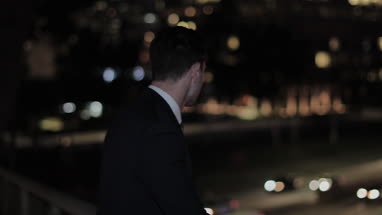 Businessman looking out at busy city