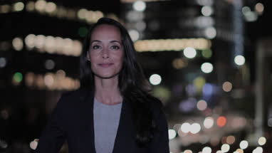Portrait of businesswoman in city at night