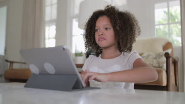 African American girl playing on a digital tablet