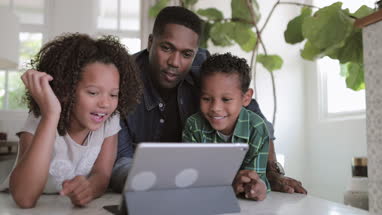 African American family using digital tablet together