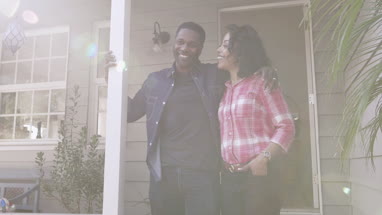 Portrait of African American couple outside home