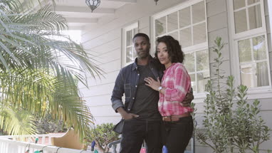 Portrait of African American couple outside home