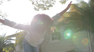 African American girl walking carefully along a wall balancing