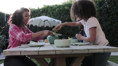 African American family having a family meal outdoors