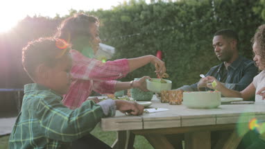 African American family having a family meal outdoors