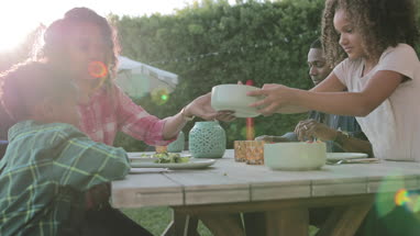 African American family having a family meal outdoors