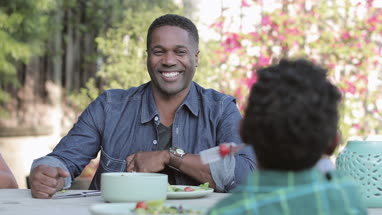 African American family having a family meal outdoors