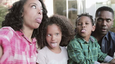 African American family pulling silly faces for a selfie