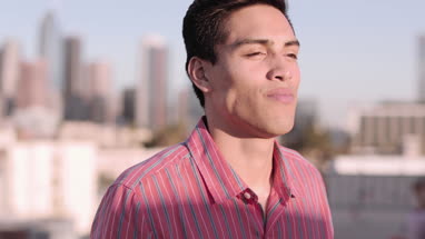 Portrait of hispanic young adult male outdoors in summer
