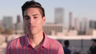 Portrait of hispanic young adult male outdoors in summer