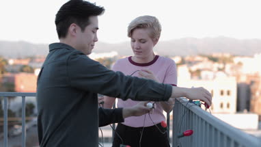 Young adult friends decorating roof terrace for a party