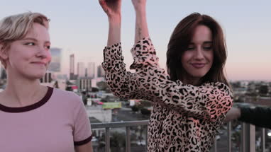 Group of friends dancing at a rooftop party