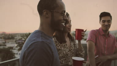 Group of friends dancing at a rooftop party