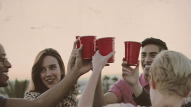 Group of friends dancing at a rooftop party