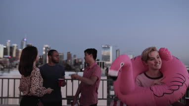 Group of friends dancing at a rooftop party