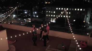 Overhead shot of group of friends dancing at a rooftop party