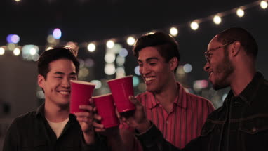 Group of male friends at a rooftop party