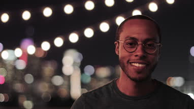 Portrait of African American young adult male outdoors in summer