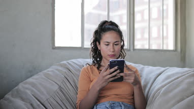 Young adult hispanic female on smartphones