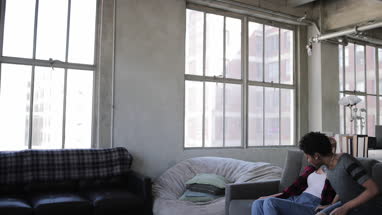 Female couple relaxing on sofa watching home entertainment
