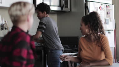 Young adult friends having coffee together in loft apartment