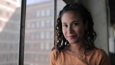 Portrait of young hispanic female looking to camera