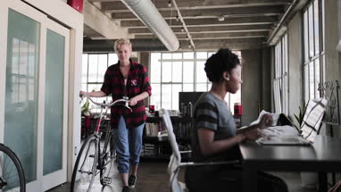 Young adults student arriving home with bicycle
