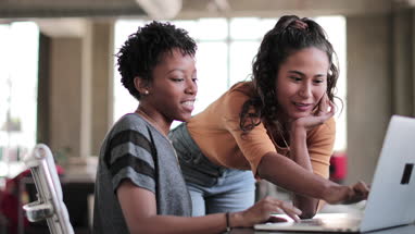 Young adults studying together in a loft apartment