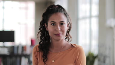 Portrait of young hispanic female looking to camera