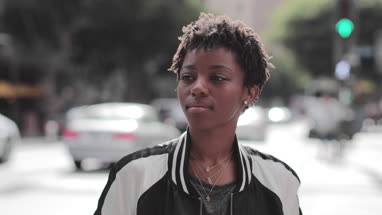 Portrait of African American young adult female on busy city street