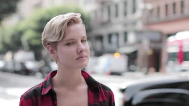 Portrait of young adult female on busy city street